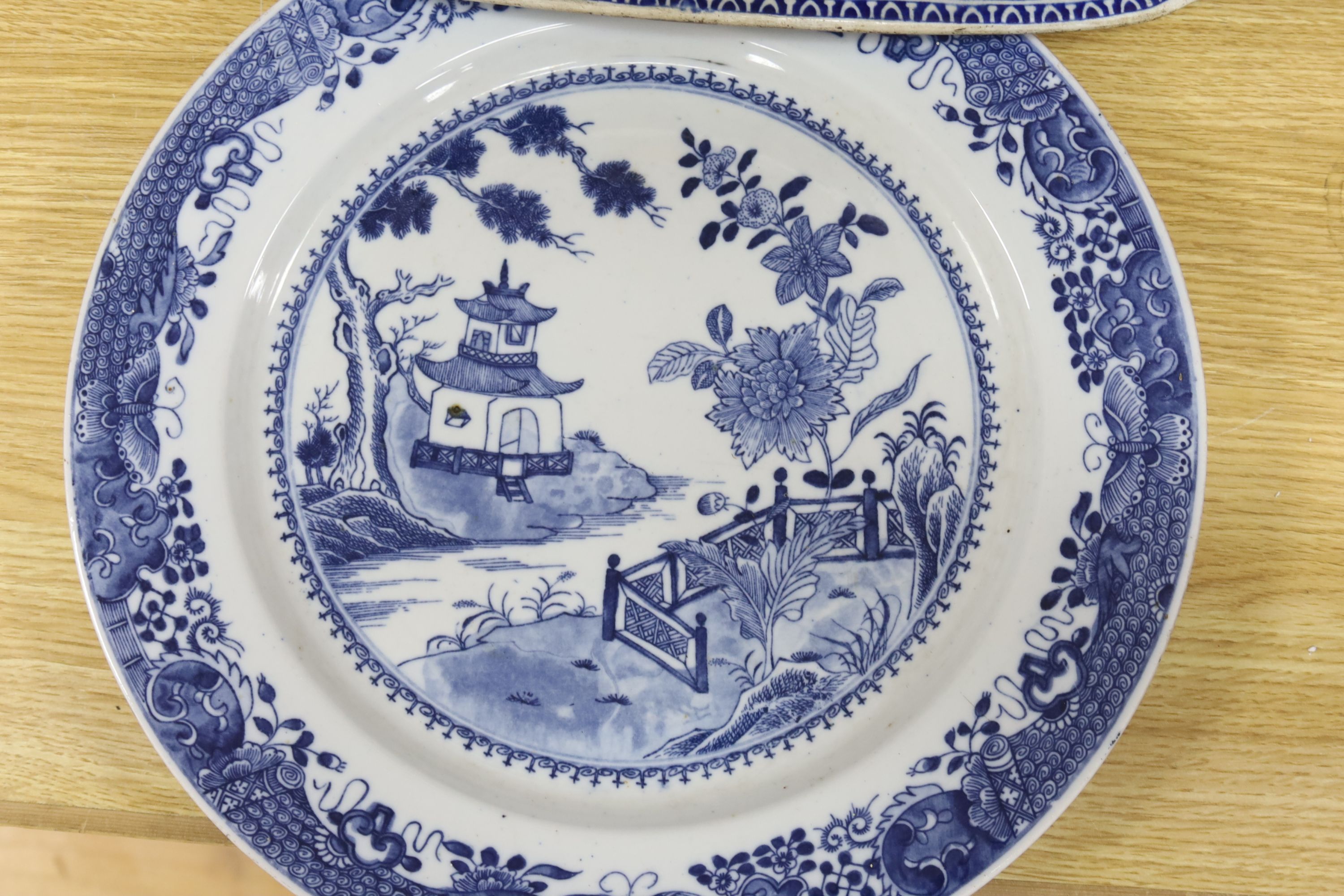 A late 19th century blue and white pottery meat dish, width 50cm, two plates and a Chinese style dish